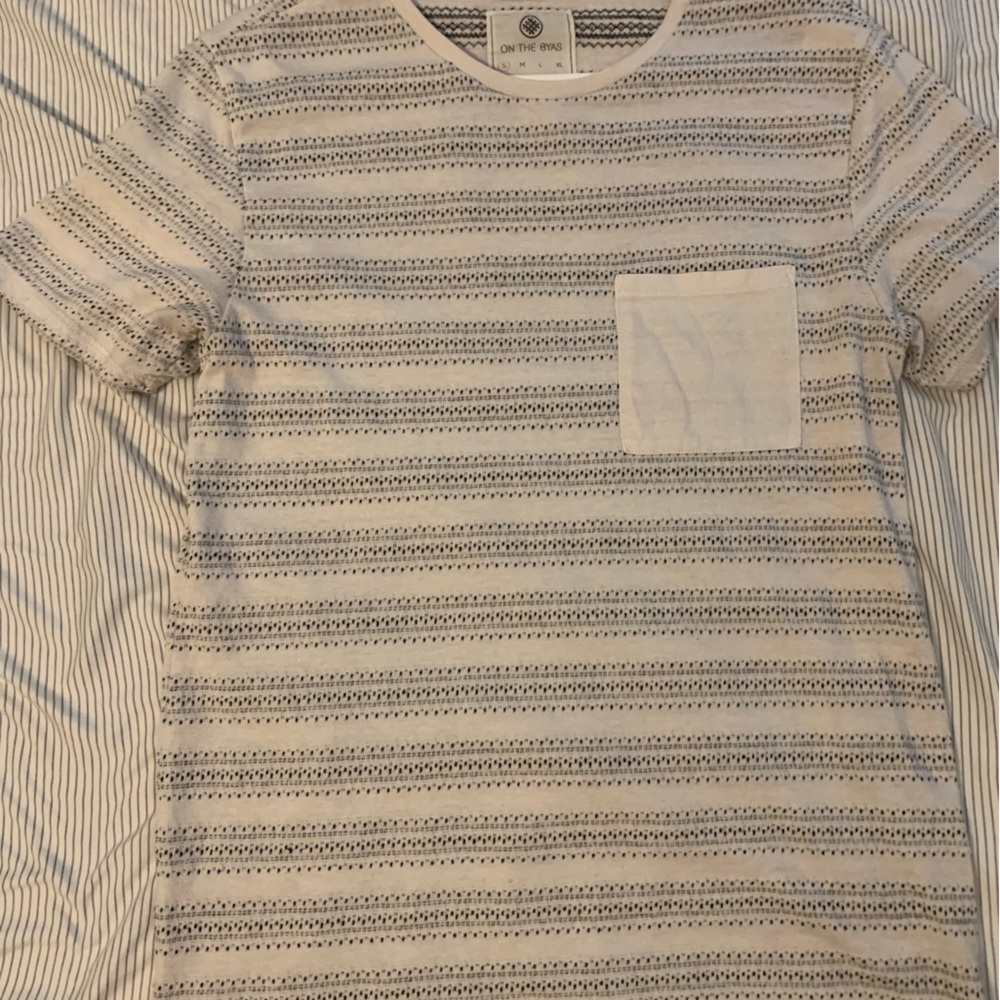 On the byas white tee shirt. Size S